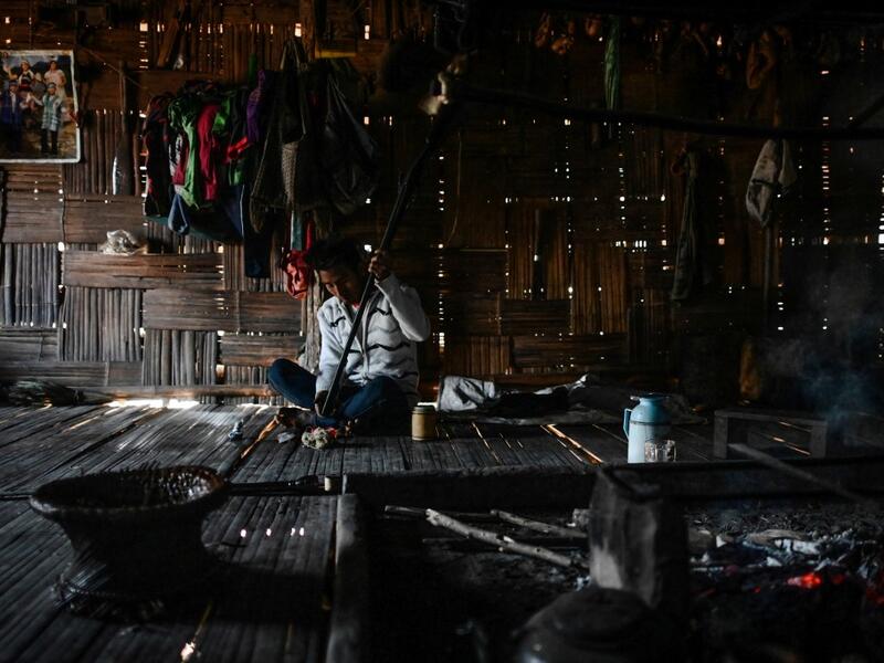 This photo taken on February 4, 2020 shows a Naga tribesman checking an old hunting rifle at his home at a village in Sagaing region of Myanmar, wedged in a semi-autonomous zone near the Indian border. People in the region subscribe to a complex patchwork of customs, intertwining their animist beliefs with warrior traditions that include striking tattoo designs, which can signify tribal identity, life accomplishments or the completion of a rite of passage. Ye Aung THU / AFP