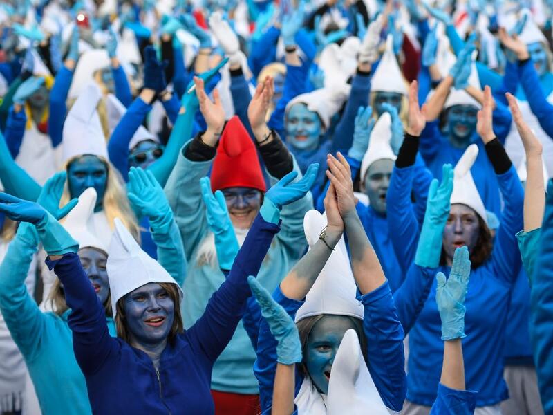 People dressed as Smurfs ('Schtroumpfs' in French), a Belgian comic franchise centered on a fictional colony of small, blue, human-like creatures who live in mushroom-shaped houses in the forest, attend a world record gathering of Smurfs on March 7, 2020, in Landerneau, western France. Damien MEYER / AFP