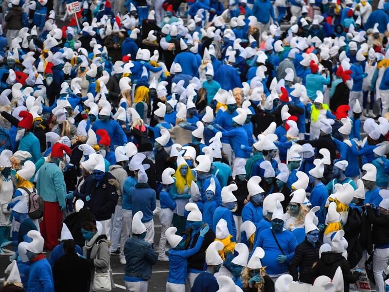 People dressed as Smurfs ('Schtroumpfs' in French), a Belgian comic franchise centered on a fictional colony of small, blue, human-like creatures who live in mushroom-shaped houses in the forest, attend a world record gathering of Smurfs on March 7, 2020, in Landerneau, western France. Damien MEYER / AFP