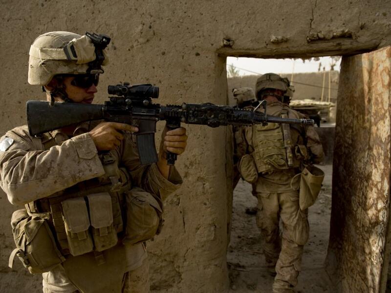 In this file photo taken on July 12, 2009, US Marines of 1st Combat Engineering Battalion of 2nd Marine Expeditionary Brigade search a compound in the Garmsir district of Helmand Province. American forces have started pulling out of two bases in Afghanistan, a US official said on March 10, 2020 the day peace talks between Kabul and the Taliban were due to start despite widespread violence and a political crisis. The United States is keen to end its longest-ever conflict, and under the terms of a deal signed