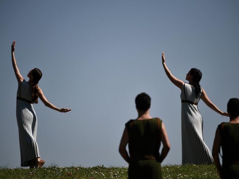 Participants dressed in ancient attire take part in the Olympic flame lighting ceremony in ancient Olympia, on March 12, 2020 ahead of Tokyo 2020 Olympic Games. ARIS MESSINIS / AFP