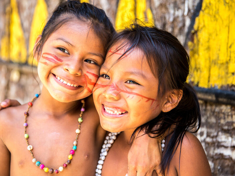 Cute Brazilian indians paying in Amazon, Brazil (Shutterstock)