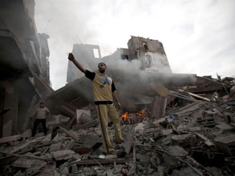 A Palestinian man stands amid debris following an Israeli air strike in Gaza City on July 11. (Photo: Mohammed Abed / AFP / Getty Images)
