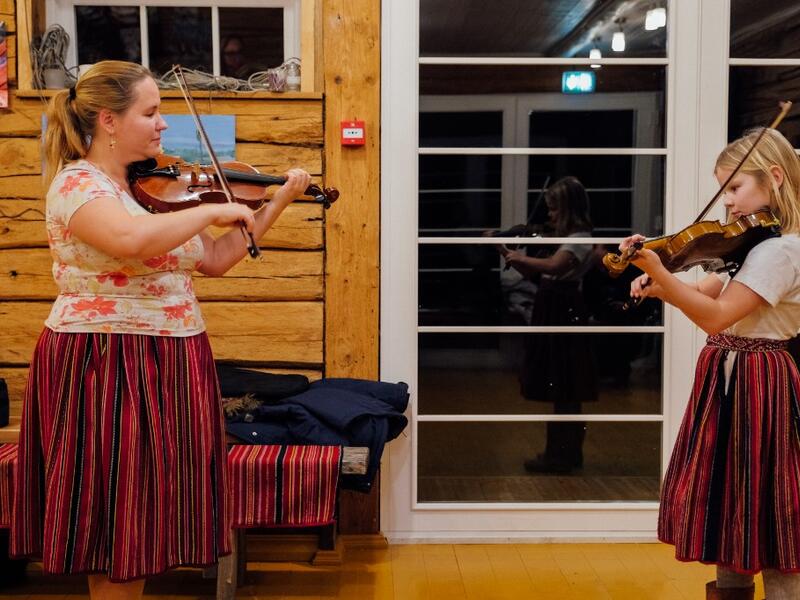 Maria Michelson, music teacher, gives a violon lesson on November 20, 2019 on Kihnu island in the Baltic Sea, 10 kilometres (six miles) off the coast of Estonia. Steeped in folk traditions, Kihnu's historic way of life however is now threatened as economic hardship drives more and more islanders away in search of work. Alessandro RAMPAZZO / AFP