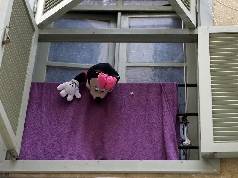 A Minnie Mouse stuffed toy dangles from a window as families are confined at home amid the COVID-19 pandemic crisis, in the historic part of the southern coastal city of Sidon (Saida), on April 6, 2020. Lebanon's President called on international donors to provide financial assistance to the crisis-hit country as it grapples with a severe economic downturn compounded by the novel coronavirus pandemic. JOSEPH EID / AFP