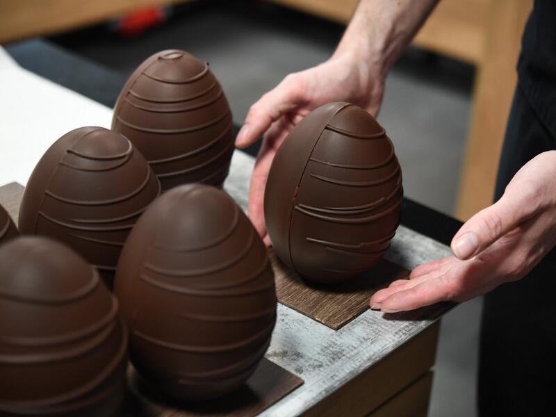 French chocolate maker Jeremy Thierry, adjusts a display chocolate Easter eggs in the workshop 'Atelier N° 5' in La Foret-Fouesnant, western France on April 7, 2020, ahead of the Christian Festival of Easter. Fred TANNEAU / AFP