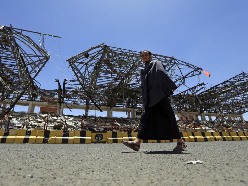 A man walks past a popular public square, which was destroyed late 2017 in an airstrike by the Saudi-led coalition, in the capital Sanaa on April 9, 2020. The Saudi-led coalition began a unilateral ceasefire in Yemen's long war, saying it hoped the initiative to prevent coronavirus in the impoverished country would lead to a wider political solution.  MOHAMMED HUWAIS / AFP