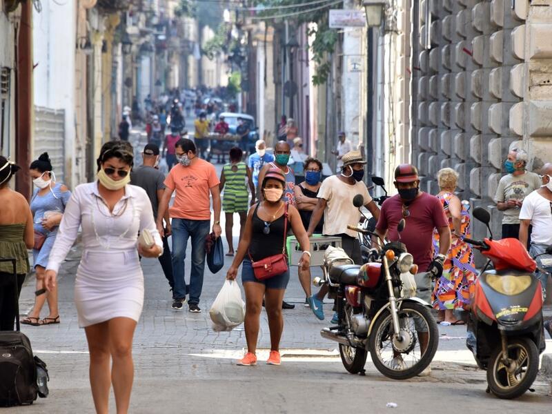People get to the street to buy food in Havana, on April 12, 2020 amid the spread of the COVID-19 disease. ADALBERTO ROQUE / AFP