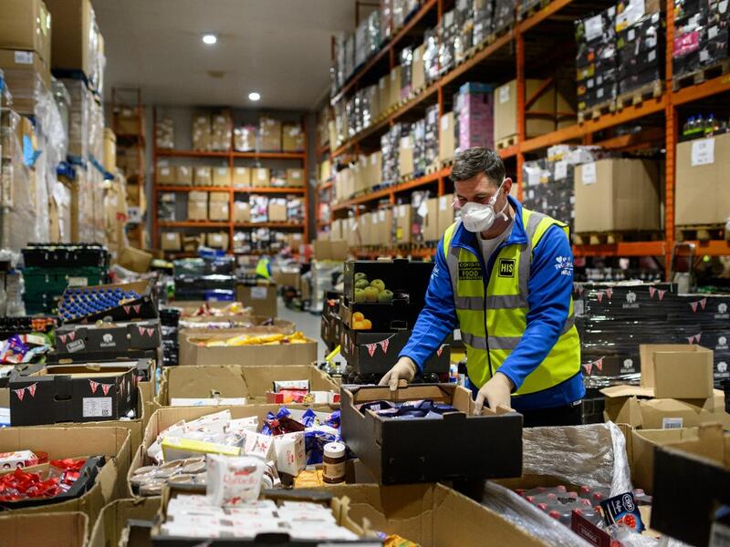 Richard Humphrey, Senior Coordinator for the charity 'His Church', helps prepare pallets of food and supplies which will be distributed to charities and community support networks across the UK from their warehouse near Market Rasen, northern England on April 14, 2020. AFP