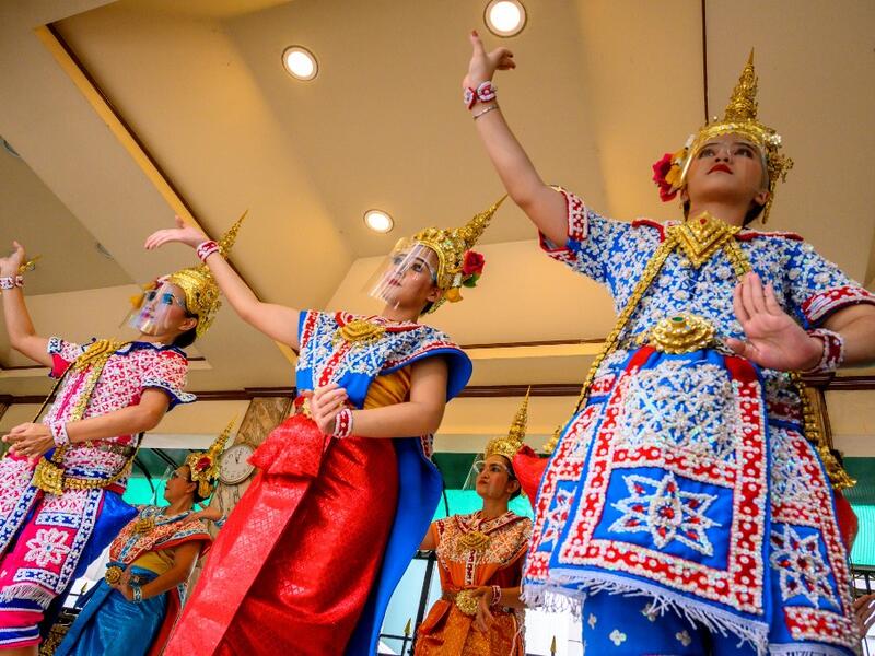 Traditional Thai dancers wearing protective face shields perform at the Erawan Shrine, which was reopened after the Thai government relaxed measures to combat the spread of the COVID-19 novel coronavirus, in Bangkok on May 4, 2020. Thailand began easing restrictions related to the COVID-19 novel coronavirus on May 3 by allowing various businesses to reopen, but warned that the stricter measures would be re-imposed should cases increase again. Mladen ANTONOV / AFP