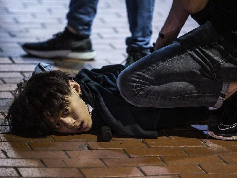 Undercover police arrest and handcuff a pro-democracy demonstrator (C) during a pro-democracy protest calling for the city's independence in Mong Kok district of Hong Kong on May 10, 2020. ISAAC LAWRENCE / AFP
