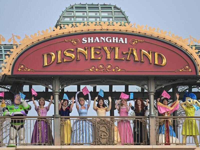 Performers dressed as Disney characters are seen during the reopening of the Disneyland amusement park in Shanghai on May 11, 2020. Disneyland Shanghai reopened on May 11 to the public after being closed since January due to the COVID-19 coronavirus outbreak. Hector RETAMAL / AFP