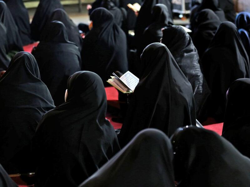 Iranian women attend Laylat al-Qadr prayers, one of the holiest nights during the Muslim fasting month of Ramadan, outside a mosque in the Tehran, on May 13, 2020. ATTA KENARE / AFP