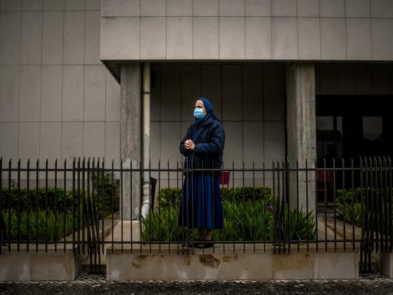 A nun wearing a face mask attends a ceremony marking the 103rd anniversary of the apparitions of Our Lady of Fatima at the Fatima shrine in central Portugal, on May 13, 2020. Without the crowd of pilgrims it welcomes every year, the shrine of Fatima celebrated the anniversary during a religious ceremony reduced to the bare minimum. PATRICIA DE MELO MOREIRA / AFP