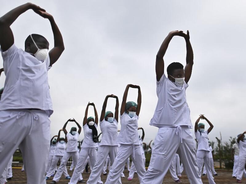 Nurses assigned to the Infectious Diseases Unit (IDU) at the Kenyatta University Hospital dance during a Zumba class held at the hospital compound in Nairobi, on May 17, 2020. Coinciding with the morning shift rotation the class, aimed to offer some respite to nurses charged with the management of patients infected with COVID-19 coronavirus, was organised by the Nursing Council of Kenya (NCK) and the Kenyatta Univesity Teaching, Refferal and Research Hospital in the Kenyan capital. TONY KARUMBA / AFP