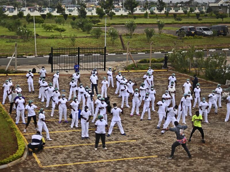 Nurses assigned to the Infectious Diseases Unit (IDU) at the Kenyatta University Hospital dance during a Zumba class held at the hospital compound in Nairobi, on May 17, 2020. Coinciding with the morning shift rotation the class, aimed to offer some respite to nurses charged with the management of patients infected with COVID-19 coronavirus, was organised by the Nursing Council of Kenya (NCK) and the Kenyatta Univesity Teaching, Refferal and Research Hospital in the Kenyan capital. TONY KARUMBA / AFP