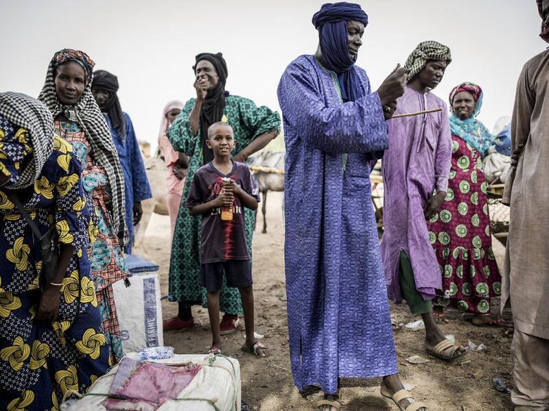 Fulani herders buy and sell goods at a unofficial herders market in Barkedji on May 28, 2020. COVID-19 coronavirus restrictions have closed down markets and regional movement, as a result Fulani herders are struggling to move to areas with more grazing land for there live stock. Closures of markets have meant that the prices for live stock has dropped by up to fifty percent, leaving the pastoralist stuck with out being able to pay for the provisions to move on. JOHN WESSELS / AFP