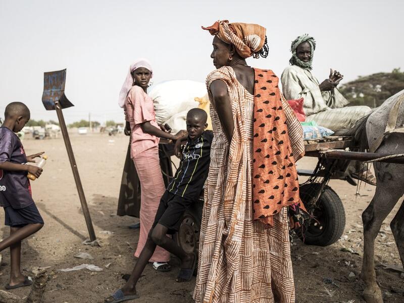 A family of Fulani herders pack their cart before making their way back to their camps after trying to buy and sell goods at a unofficial herders market in Barkedji on May 28, 2020. COVID-19 coronavirus restrictions have closed down markets and regional movement, as a result Fulani herders are struggling to move to areas with more grazing land for there live stock. Closures of markets have meant that the prices for live stock has dropped by up to fifty percent, leaving the pastoralist stuck with out being a