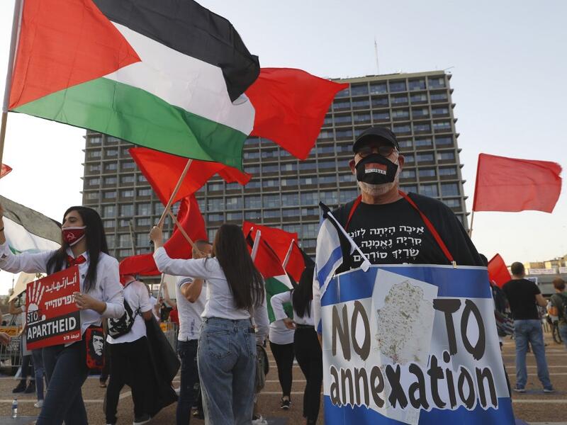 Protesters gather in Tel Aviv's Rabin Square on June 6, 2020, to denounce Israel's plan to annex parts of the occupied West Bank. Israeli Prime Minister Benjamin Netanyahu has vowed to forge ahead with annexing settlements and the Jordan Valley, in line with the peace proposals unveiled in January by US President Donald Trump. The plan has been angrily rejected by the Palestinians, who say they were not consulted on proposals they see as capitulating to Israeli demands. JACK GUEZ / AFP