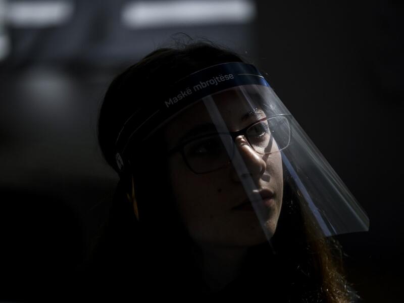 A student wearing a 3D printed face shield and gloves attends a class at the "Faik Konica" primary school in Pristina on June 9, 2020, as the schools in Kosovo gradually reopen, after almost three months of restrictions due to the risk of Covid-19 pandemic caused by the novel coronavirus. Armend NIMANI/AFP Armend NIMANI / AFP