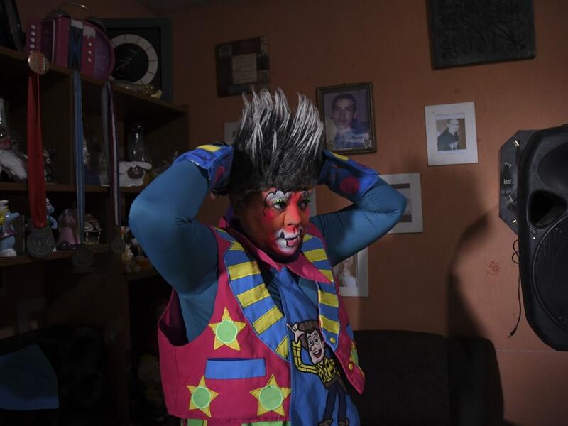 Mostacita.com clown prepares before taking to the streets to beg for money to survive the crisis caused by the new coronavirus in Villa Nueva, 20 km south Guatemala City, on June 10, 2020, as clowns have been unable to work due to restrictions to prevent the spread of the COVID-19.  Johan ORDONEZ / AFP