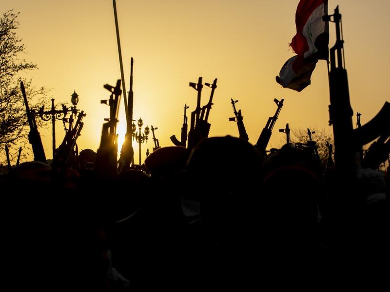 Members of the Hashed al-Shaabi (Popular Mobilisation) paramilitary force take part in a military parade in the southern Iraqi city of Basra on June 14, 2020, marking the sixth anniversary of its founding after Iraq's top Shiite cleric Grand Ayatollah Ali Sistani called to defend the country from the Islamic State group (IS). Hussein FALEH / AFP