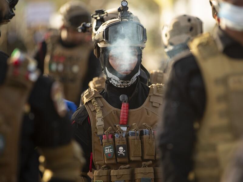 Members of the Hashed al-Shaabi (Popular Mobilisation) paramilitary force take part in a military parade in the southern Iraqi city of Basra on June 14, 2020, marking the sixth anniversary of its founding after Iraq's top Shiite cleric Grand Ayatollah Ali Sistani called to defend the country from the Islamic State group (IS). Hussein FALEH / AFP