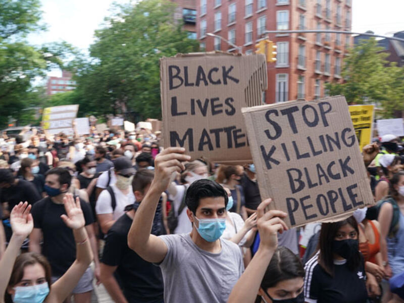 Protesters march and carry signs in the West Village as they demonstrate in outrage over the death of George Floyd, who died while in custody of the Minneapolis police, at a rally on May 30, 2020 in New York. AFP