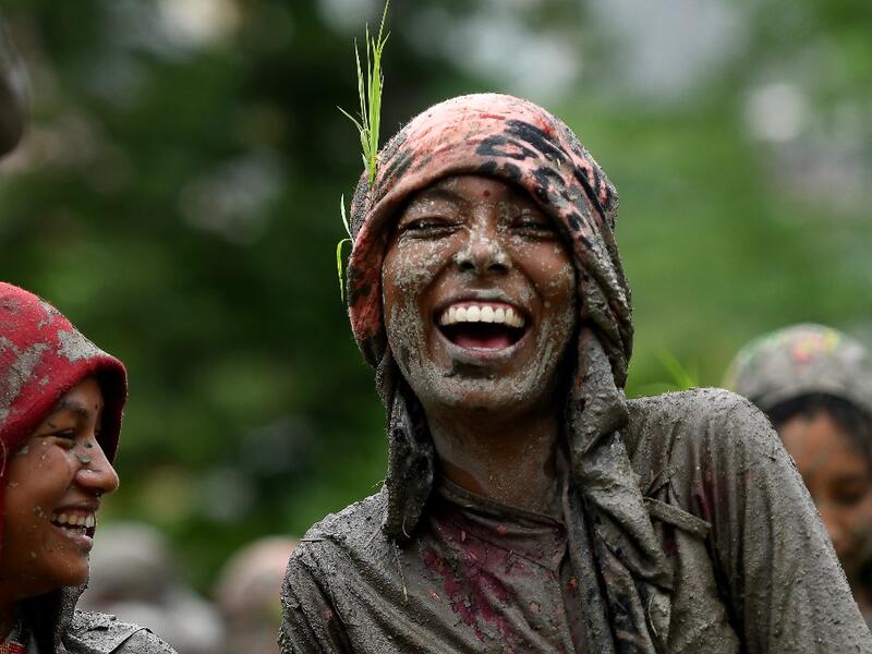 Splashing mud and drinking local rice beer, Nepali farmers this week celebrated National Paddy Day to mark the beginning of the rice-planting season, despite some coronavirus lockdown measures still in place. Traditional farming songs and laughter echoed in the air as farmers waded into waterlogged fields to sow green paddy.  PRAKASH MATHEMA / AFP
