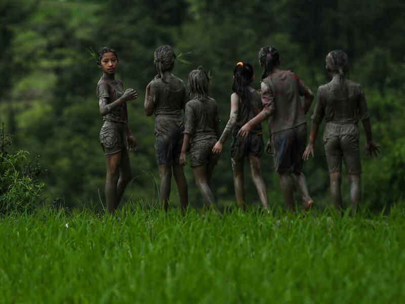 Splashing mud and drinking local rice beer, Nepali farmers this week celebrated National Paddy Day to mark the beginning of the rice-planting season, despite some coronavirus lockdown measures still in place. Traditional farming songs and laughter echoed in the air as farmers waded into waterlogged fields to sow green paddy.  PRAKASH MATHEMA / AFP