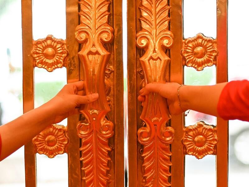 Hotel staff wait to welcome guests in the lobby of the newly-inaugurated Dolce Hanoi Golden Lake hotel, the world's first gold-plated hotel, in Hanoi on July 2, 2020. Manan VATSYAYANA / AFP