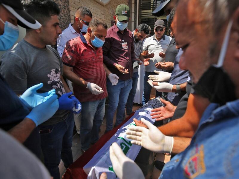 Mourners pray over the coffin of slain Iraqi jihadism expert Hisham al-Hashemi, who was shot dead yesterday outside his house in the Iraqi capital, during his funeral in Baghdad’s Zayouna district on July 7, 2020. Hashemi was an authoritative voice on Sunni jihadist factions including the Islamic State group, but was also frequently consulted by media and foreign governments on domestic Iraqi politics and Shiite armed groups. He had warm ties with top decision-makers, including President Barham Saleh.