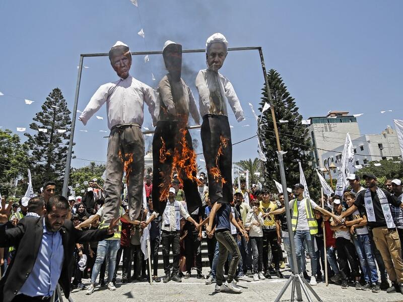 Palestinian supporters of al-Ahrar movement burn effigies depicting (L to R) US President Donald Trump, Trump's Middle East peace plan dubbed as the "Deal of the Century", and Israeli Prime Minister Benjamin Netanyahu, during a demonstration against Israel's plans to annex parts of the occupied West Bank. MOHAMMED ABED / AFP