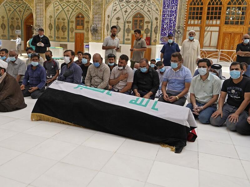 Mourners pray over the coffin of slain Iraqi jihadism expert Hisham al-Hashemi, who was shot dead yesterday outside his house in the Iraqi capital, before his burial on July 7, 2020 in the Shiite shrine city of Najaf in central Iraq. The killing of the 47-year-old prominent expert has stirred fears Iraq is entering a dark and violent phase, as boiling tensions between pro-Iran factions and the government reach new heights. AFP