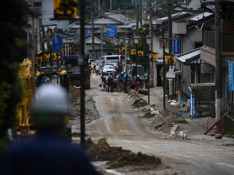 Debris litter a village following heavy rains and flooding in the village of Gero, Gifu prefecture on July 9, 2020. Japanese emergency services and troops were scrambling to reach thousands of homes cut off by devastating flooding and landslides that have killed dozens and caused widespread damage. Philip FONG / AFP