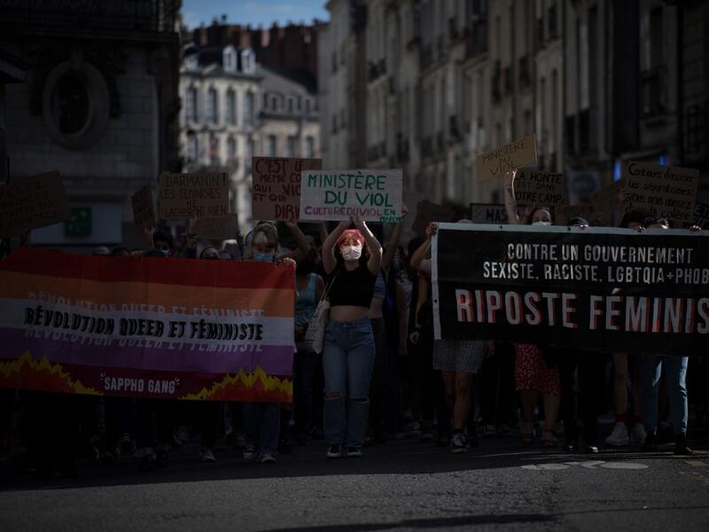 Protesters hold signs and banners as they take part in a demonstration called by feminist movements in Nantes, western France, on July 10, 2020, to denounce the nomination of French Interior Minister, facing rape accusations and French Justice Minister who criticised the #MeToo movement against sexual harassment. LOIC VENANCE / AFP