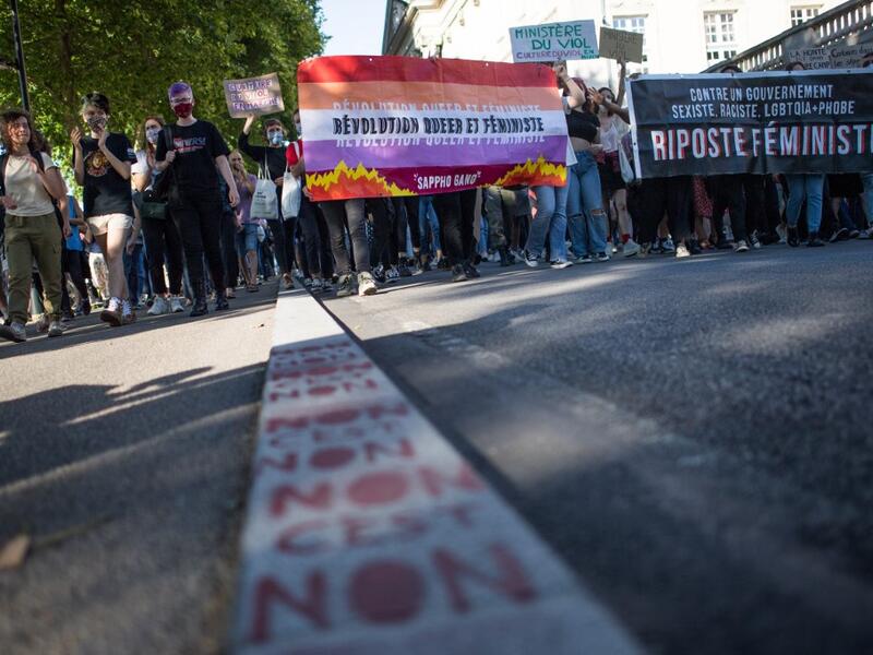 Protesters hold signs and banners as they take part in a demonstration called by feminist movements in Nantes, western France, on July 10, 2020, to denounce the nomination of French Interior Minister, facing rape accusations and French Justice Minister who criticised the #MeToo movement against sexual harassment. LOIC VENANCE / AFP