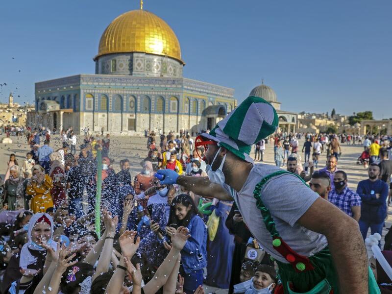 Palestinian Muslim worshippers gather at the al-Aqsa Mosque compound in Jerusalem's old city on the first day of Eid al-Adha on July 31, 2020. Eid al-Adha (the Festival of Sacrifice) is celebrated throughout the Muslim world as a commemoration of Abraham's willingness to sacrifice his son for God, and cows, camels, goats and sheep are traditionally slaughtered on the holiest day AHMAD GHARABLI / AFP