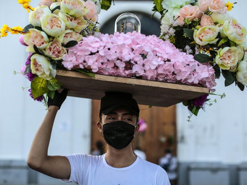 A Catholic faithful wears a face mask as a preventive measure against the spread of the novel coronavirus, COVID-19, during the opening of the ten-day celebration of the Santo Domingo de Guzman festival, outside the Las Sierritas de Santo Domingo church in Managua, on August 1, 2020. Despite the Catholic Church cancelling all religious activities due to the coronavirus pandemic, devotees gathered outside the church for the celebration. Inti OCON / AFP