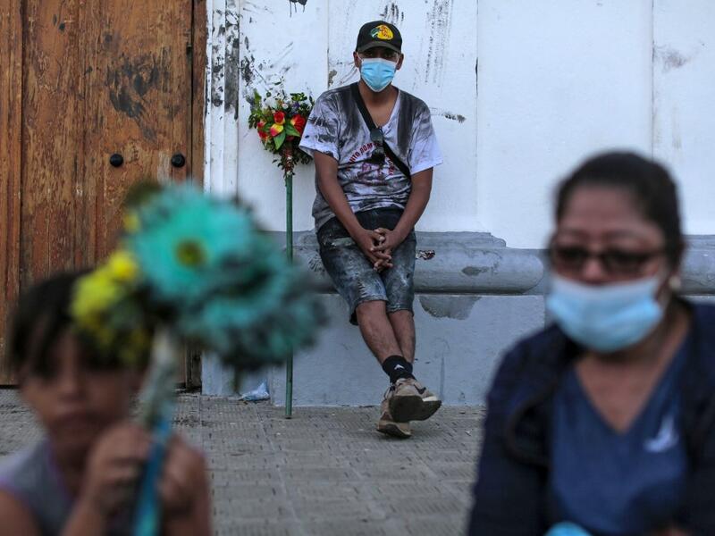 Catholic faithfuls wear face masks as a preventive measure against the spread of the novel coronavirus, COVID-19, during the opening of the ten-day celebration of the Santo Domingo de Guzman festival, outside the Las Sierritas de Santo Domingo church in Managua, on August 1, 2020. Despite the Catholic Church cancelling all religious activities due to the coronavirus pandemic, devotees gathered outside the church for the celebration. Inti OCON / AFP