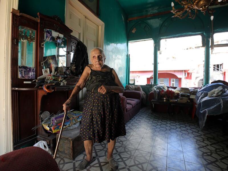 Rose Ghoulam, 90-years-old, stands in her damaged house in the damaged neighbourhood Gemmayze in the Lebanese capital Beirut on August 6, 2020, two days after a massive explosion shook the Lebanese capital. The blast, which appeared to have been caused by a fire igniting 2,750 tonnes of ammonium nitrate left unsecured in a warehouse, was felt as far away as Cyprus, some 150 miles (240 kilometres) to the northwest. The scale of the destruction was such that the Lebanese capital resembled the scene of an eart