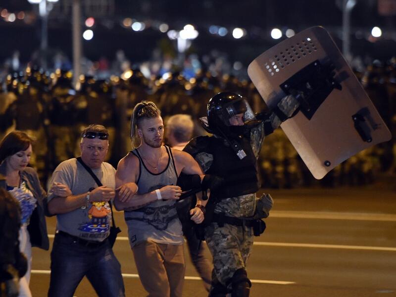 Riot police detain a group of demonstrators during a protest after polls closed in Belarus' presidential election, in Minsk on August 9, 2020. Sergei GAPON / AFP