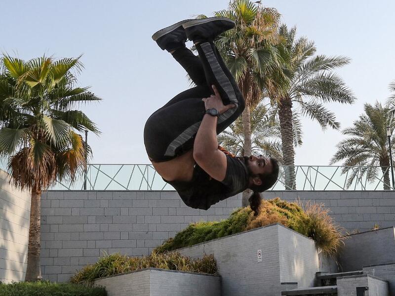 Hamzar Mekkaoui, 26, performs parkour, a sport that originated in France in the 1990s, which involves getting around urban obstacles with a fast-paced mix of jumping, vaulting, running and rolling, in the Qatari capital Doha, on August 11, 2020. Parkour, also known as free-running, has now found a small but committed following in Qatar despite evening temperatures that hover around 40 degrees Celsius (104 Fahrenheit) in summer and over-zealous security guards unfamiliar with the sport. KARIM JAAFAR / AFP
