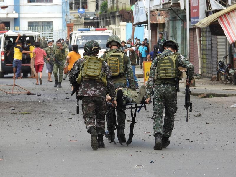 Soldiers stretcher away a comrade after an improvised bomb exploded next to a military vehicle in the town of Jolo on Sulu island on August 24, 2020. Nickee BUTLANGAN / AFP