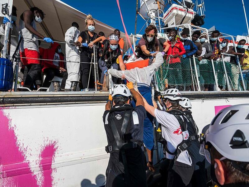 On Wednesday, 45 people – including five children – died when the engine on their boat exploded off the coast of Libya. A migrant being lowered onto Sea-Watch 4 (AFP)