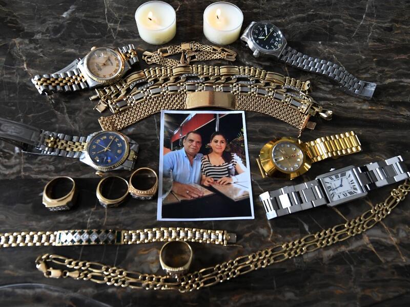 Picture of a photo and jewellery which belonged to Honduran journalist David Romero, head of Globo radio and TV station, who died of complications from the novel coronavirus COVID-19 on July 18, taken at his house in Tegucigalpa, on July 22, 2020. Global deaths from the coronavirus have almost reached on September 25, 2020 the grim threshold of one million. Around one-third of fatalities were in Latin America, where countries with overstretched medical resources are preparing for a further onslaught. Orland