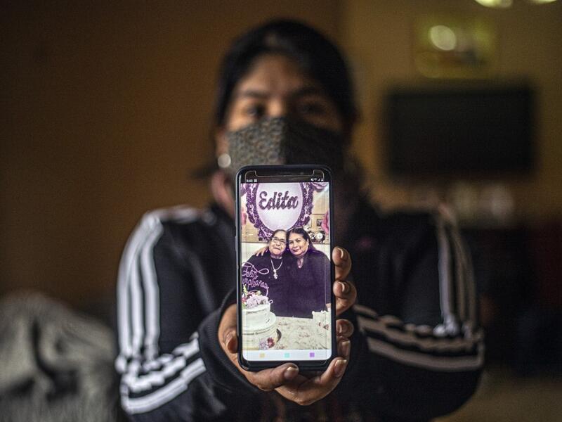 Peruvian Julizza Navarro, 32, shows a picture of her mother Maribel Diaz (R), 52, and her grandmother Edita Leiva (L), 76, who died from COVID-19, at her home in Chorrillos, south of Lima, Peru on August 11, 2020. Global deaths from the coronavirus have almost reached on September 25, 2020 the grim threshold of one million. Around one-third of fatalities were in Latin America, where countries with overstretched medical resources are preparing for a further onslaught. ERNESTO BENAVIDES / AFP