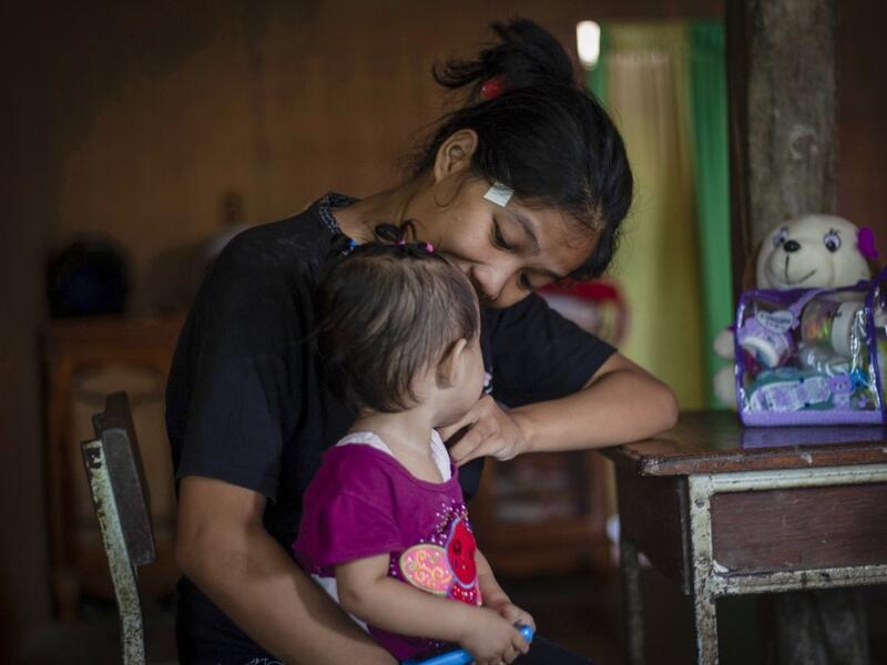 This picture taken on February 9, 2019 shows Nurlina, 19, who got married in 2017, holding her daughter in the village of Galung Lombok in West Sulawesi. Child marriage has long been common in traditional communities from the Indonesian archipelago to India, Pakistan and Vietnam, but numbers had been decreasing as charities made inroads by encouraging access to education and women's health services. YUSUF WAHIL / AFP
