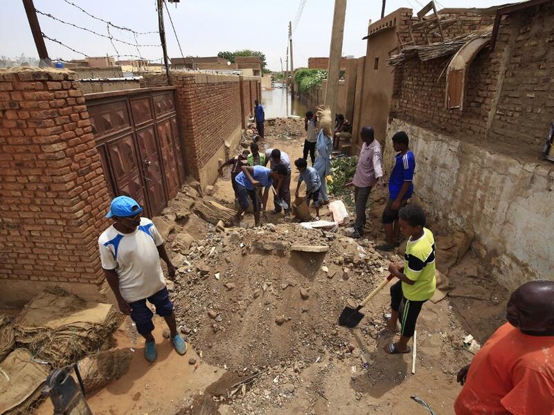 On Tuti Island, the highest Nile waters since records began a century ago have left people struggling to build dams by filling bags with sand and small stones to stem the flood. ASHRAF SHAZLY / AFP