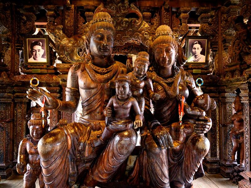 This photograph taken on September 1, 2020 shows the family statue with the portraits of the Thai businessman Lek Viriyaphan, who designed the temple, and his wife Prapai Viriyaphan in the all wooden Sanctuary of Truth Hindu-Buddhist temple and museum in Pattaya. Mladen ANTONOV / AFP